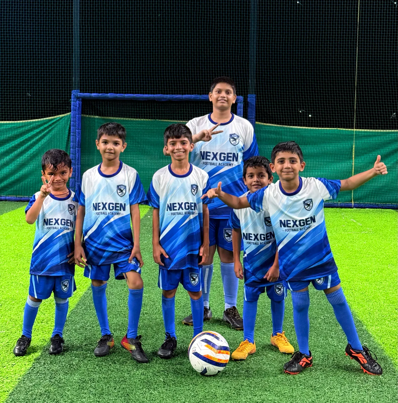 NexGen players posing together on the pitch after training